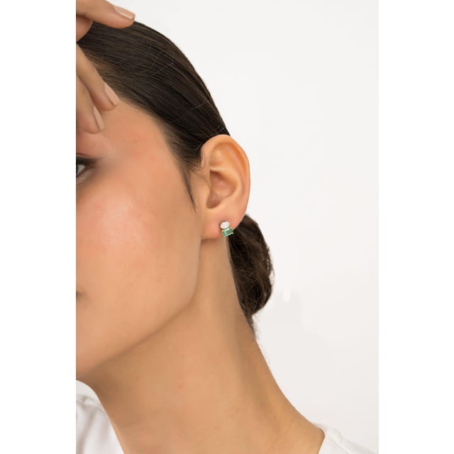 These elegant studs featuring 0.77 carat of emerald-cut green emerald set in 18K white and yellow gold, Each measuring...