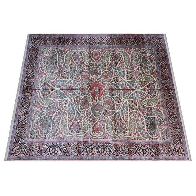 This magnificent 9'x12' masterpiece is a quintessential example of Kashmir Art Silk weaving, blending centuries of floral...