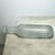 Antique late-19th-century aqua glass bottle with a distinctive rounded base, elongated neck, and substantial blob-style...
