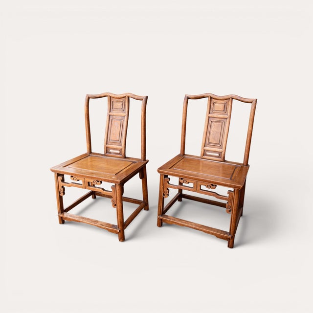 Elegant pair of Chinese Ming-style hardwood scholar chairs dating to the Late Qing / Early Republic period. Featuring...