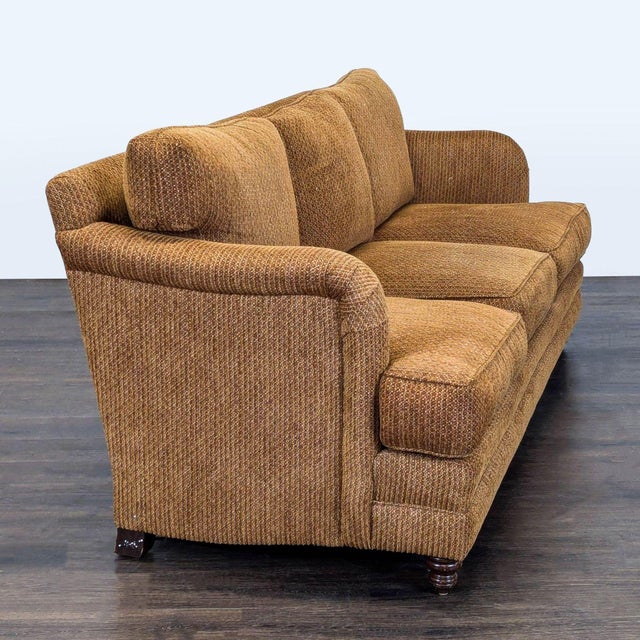 This 3-seat sofa features a warm brown textured fabric and classic rolled arms. It offers plush, comfortable cushions and...