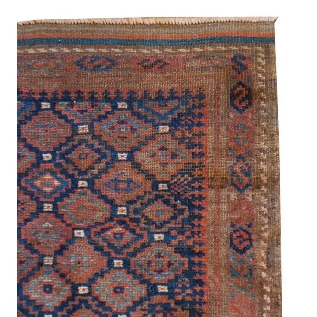 A special, petite, late-19th century Persian Baluch rug with an all-over small-scale diamond pattern woven with light and...