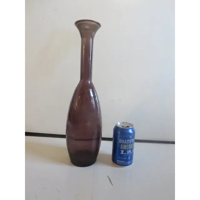 Offered is an interesting amethyst 15.75" decanter, lacking a stopper. Would work well as a vase. There is no label or...