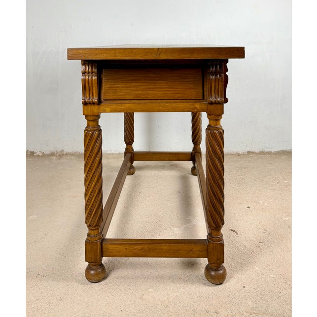 Handsome Spanish console table crafted in solid oak, featuring two drawers with geometric carved fronts, beautifully...