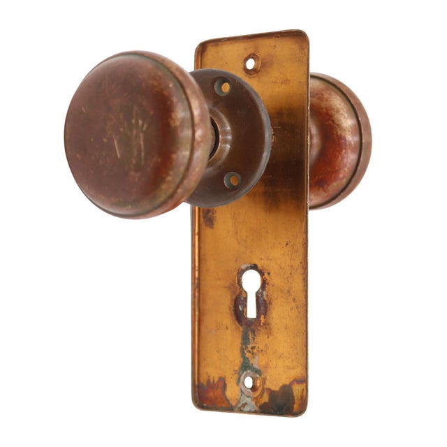 Classic style passage door knob set made of brass with a warm patina finish. Priced as two door knobs, one back plate, one...