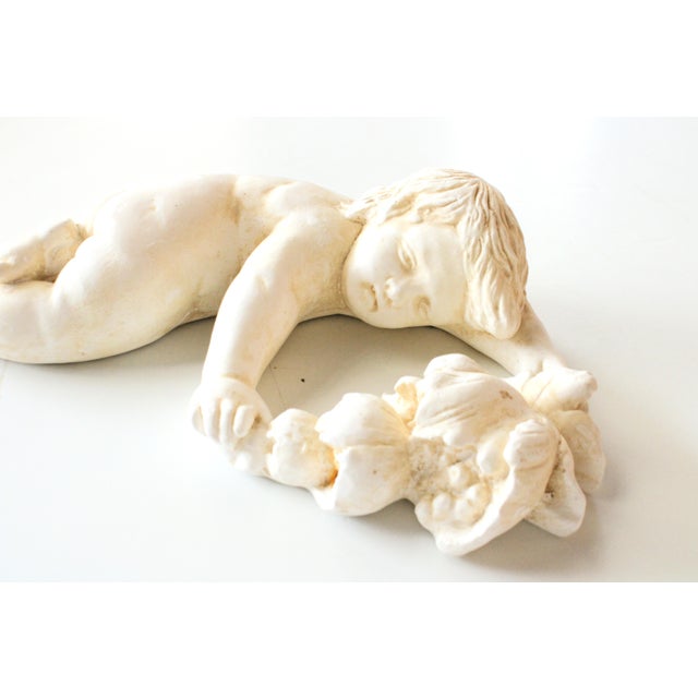 Sculptural garden Cherub with Garland, for indoor or outdoor use. Embedded wire for hanging. Want to explore more products...