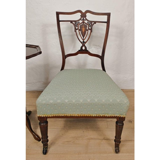 This period nursing chair has gorgeous inlaid carved features that truly highlight the craftsmanship of the Edwardian era....