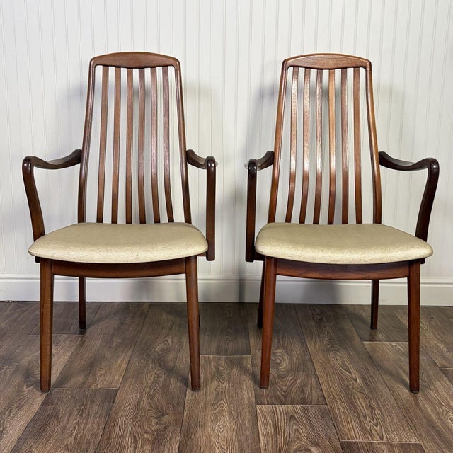Vintage pair of MCM high back armchairs in a Danish modern style, with wood frames and original upholstered seats. Each...