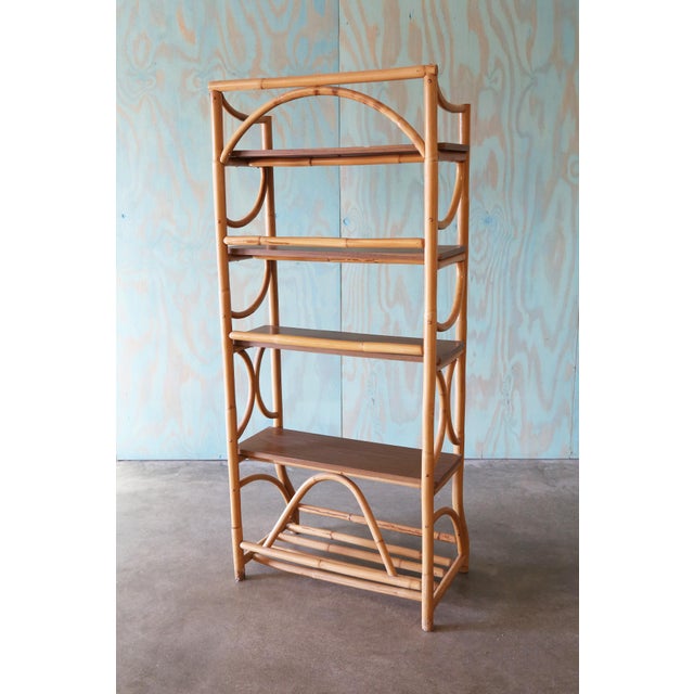 Sculptural bamboo shelf with a bamboo frame and laminate wood shelving. A wider bottom and a narrower top. Flowing...