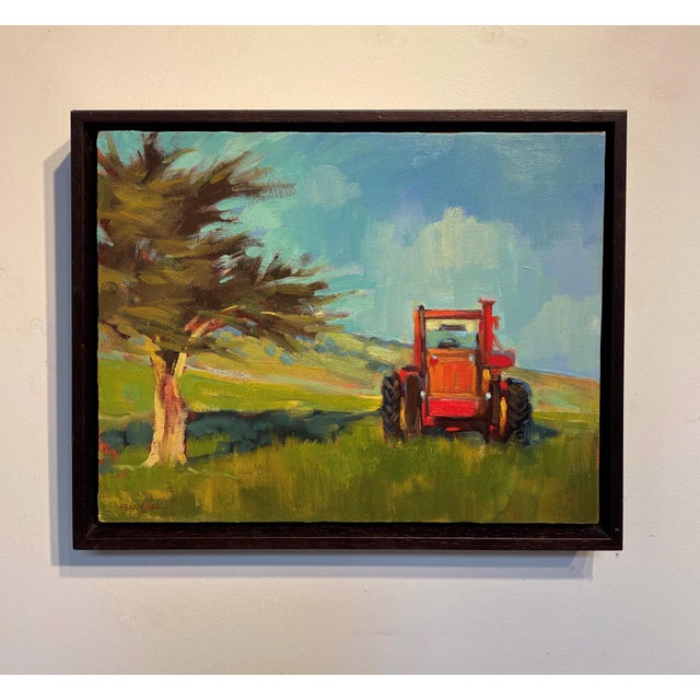 This oil painting depicts a vibrant red tractor set against a backdrop of rolling hills and a solitary tree, capturing a...