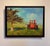 This oil painting depicts a vibrant red tractor set against a backdrop of rolling hills and a solitary tree, capturing a...