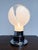A distinctive Murano glass table lamp from Italy, dating back to the 1970s. Standing an impressive 52 cm tall, this lamp...