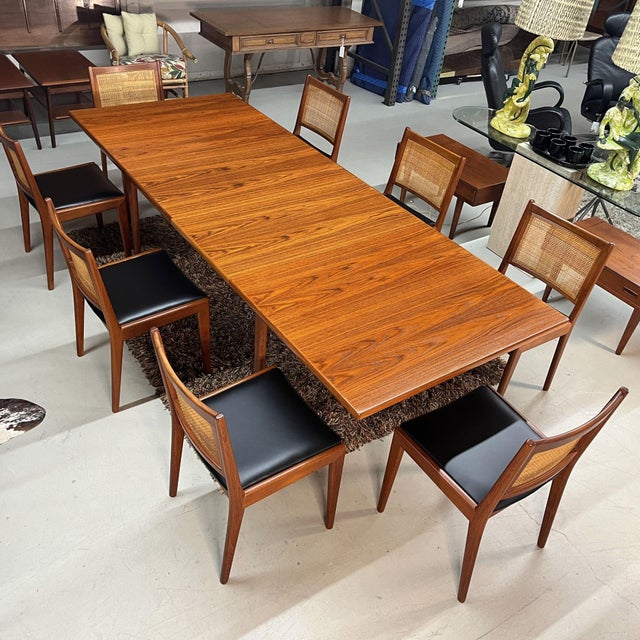A generously scaled Danish dining table in richly grained teak, built with the restrained architectural vocabulary that...