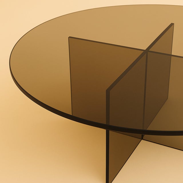 The Arki is a bronzed glass coffee table, a study in transparency built from Italian glass rather than stone. It trades...