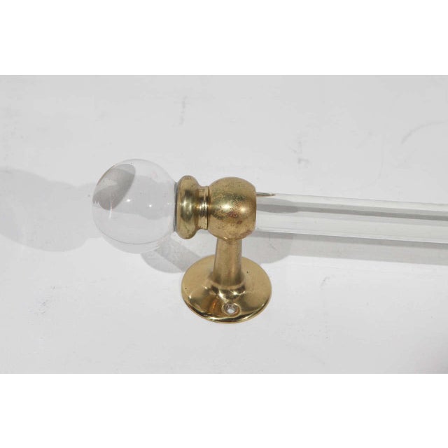 42 inch long glass towel bar with brass ends. Round glass caps at end. Bar is 1 inch in diameter. One available.