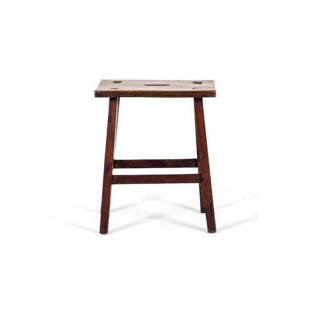 A simple vernacular oak stool of joint construction with a thick block top complemented with an oval recess carry handle....