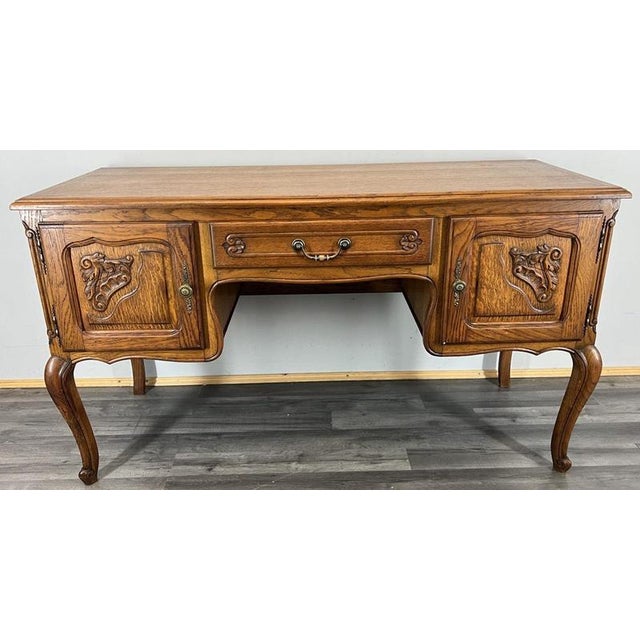a beautifully crafted vintage french louis cabinet designed as a tv stand , featuring elegant carved door panels, refined...