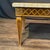 Elegant French carved walnut coffee table, mid-20th century, topped with a rectangular marble slab displaying warm,...