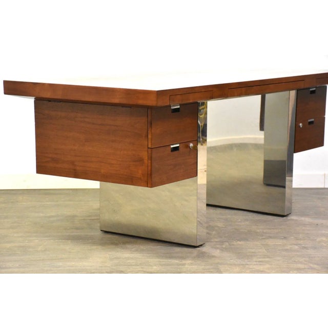 A beautiful mid century modern walnut and chrome executive desk finished on all sides designed by Roger Sprunger for...