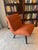 This striking Room & Board armless accent chair is a true design statement, upholstered in a rich terracotta/burnt orange...