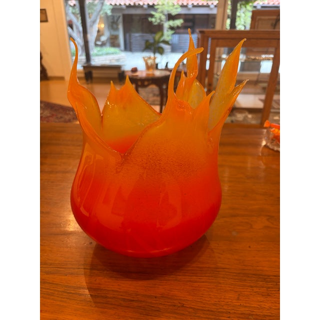 A dramatic hand-blown art-glass vessel by Cohn-Stone Studios, dated 2004. The sculptural form transitions from deep ruby...