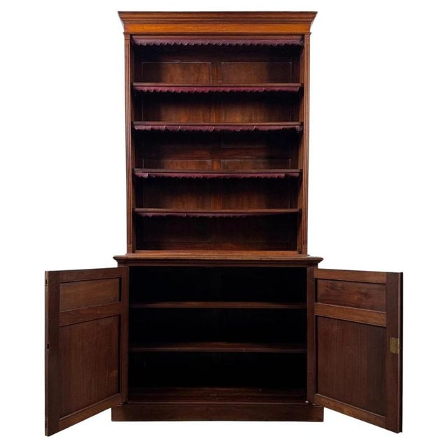 An impressive early 20th-century English tall open bookcase, finely crafted from mahogany and combining substantial open...