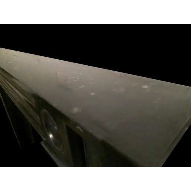 A bespoke surround in Irish Kilkenny marble, typical of the early 19th century with moulded panels to Jambs and frieze,...