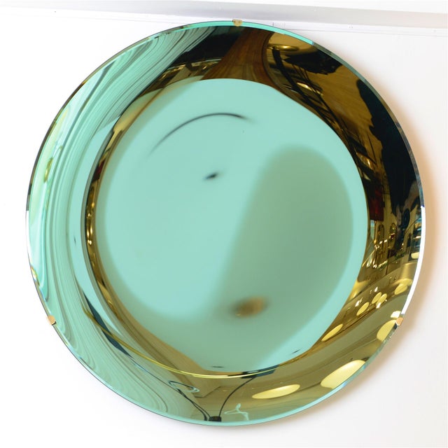 Anish Kapoor style concave mirror. Sculptural green glass mirror, with brass wall fixing. Excellent quality mirror with...