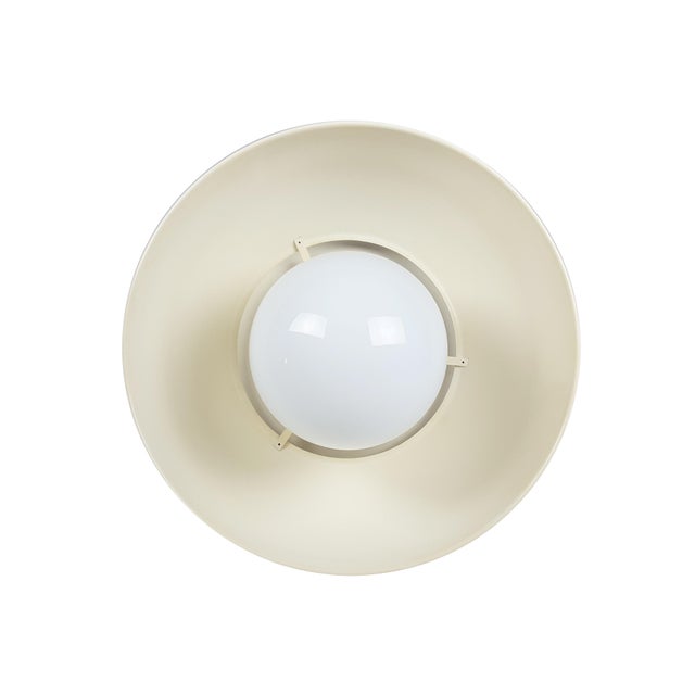 This vintage pendant was produced by Artemide with painted brass & metal shades and white opaline glass sphere. the white...