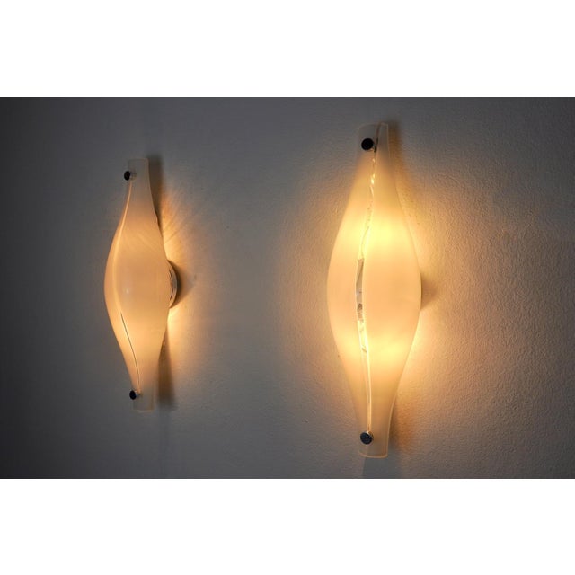 Very nice pair of "cat's eye" sconces designed and produced by Mazzega in Murano, Italy in the 60s. This magnificent pair...