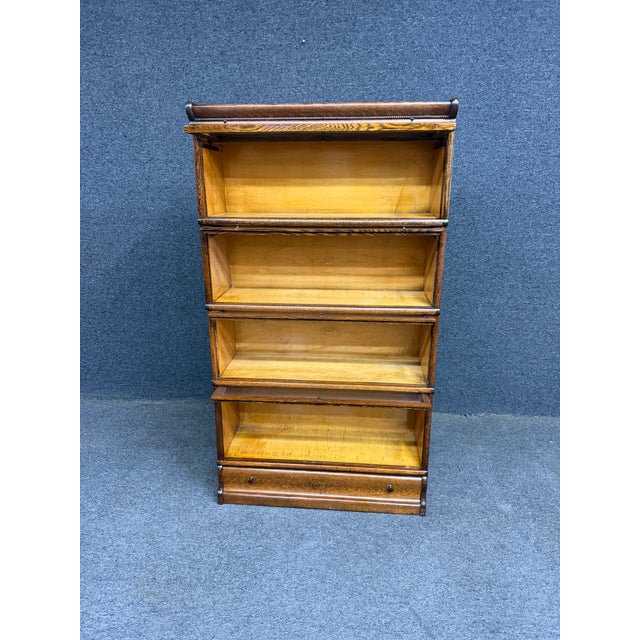 Exceptional early 20th-century Macey sectional bookcase crafted in quarter-sawn oak, consisting of four stacking sections...