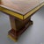 A fine Art Deco cocktail table designed by Jean Desnos. Marquetry patterned top. Table border surrounded by eglomise glass...