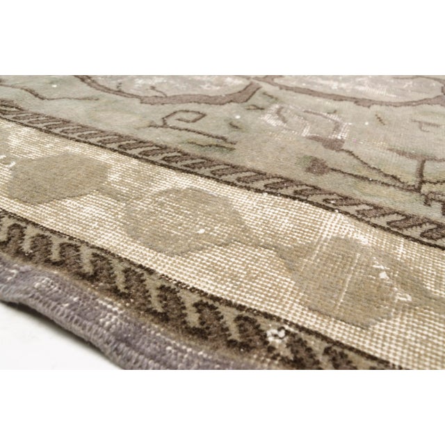 This is a vintage Turkish Oushak rug from the 1960s. The piece was hand-knotted.