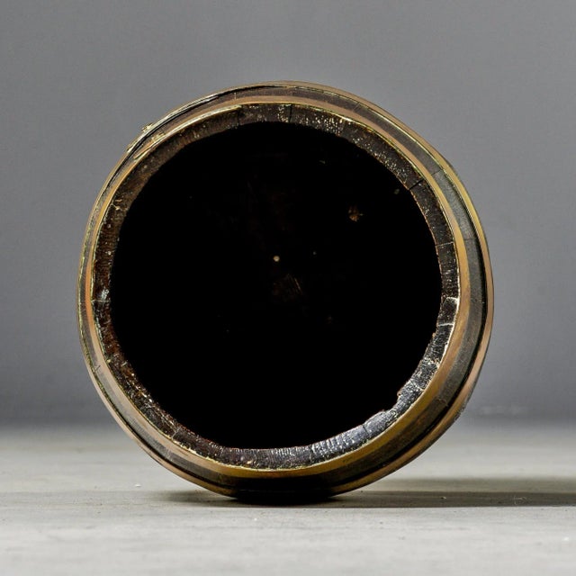 Circa early 1900s English barrel is just over 14” tall. Made of dark oak with four polished brass bands. Unknown maker. We...