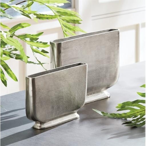 The Large Silver Pendleton Metal Vase Dimensions: 15.75 x 3 x 11.5 Designed with a shallow profile, this simple vase is...