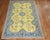 An antique Turkish Oushak with an unusual bright sunny yellow ground outlined by teal border. Measure: 6'1" x 9'9".