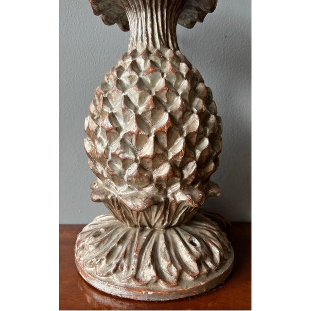 Carved wood and silver leaf stylized pineapple form lamp.