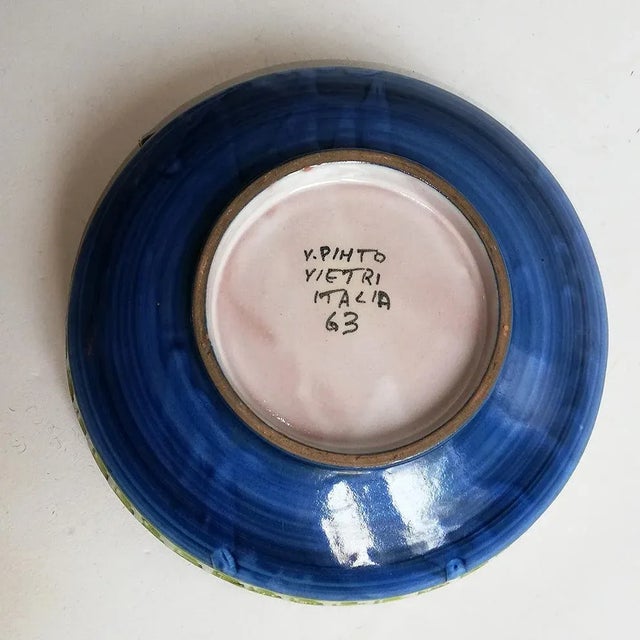This ceramic plate with a floral motif dates from 1963 and is signed 'Pinto Vietri Italian 63'.
