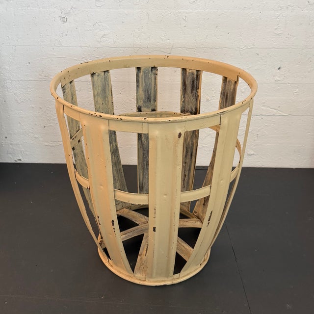 This rustic, industrial bin basket features an open strap metal construction in a patinated beige finish. The application...
