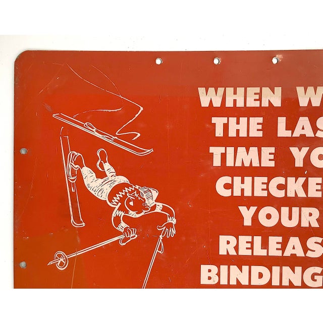 Circa 1950s one sided metal red and white sign with skiing tips from The Boston Globe with skier graphics. Sign has holes...