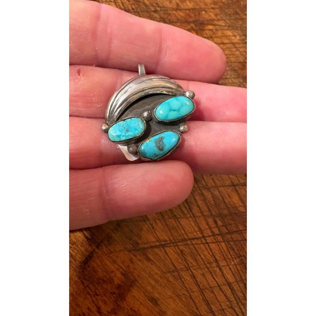 vintage Native American Navajo sterling silver pendant featuring three natural turquoise cabochons and a scalloped or...