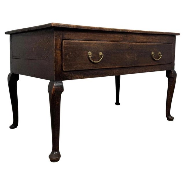 A superb and highly distinctive 18th-century English Georgian side table, finely constructed in oak and particularly...