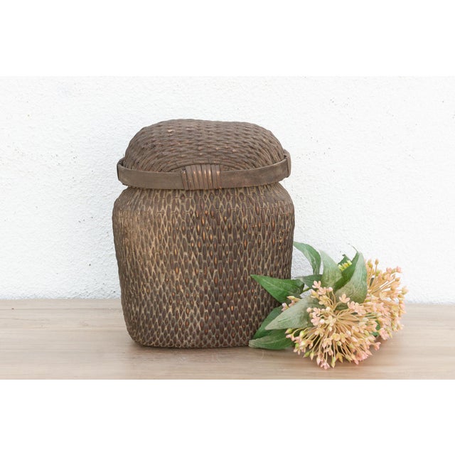 Discover the honest beauty of traditional hand-craftsmanship with this magnificent antique lidded basket. Measuring...