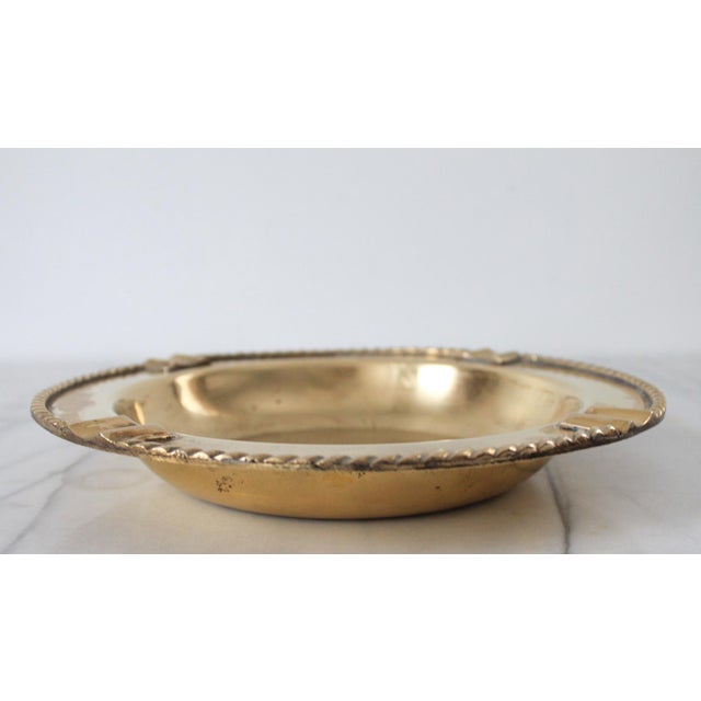 Vintage brass ashtray or catchall. No makers mark. Signs of age wear and use.