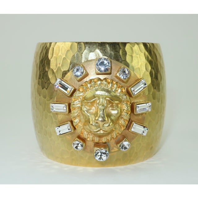 Late 20th Century Gerard Yosca gold plated cuff bracelet with a hammered finish and a regal lion medallion framed in...