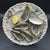 This is a trompe-l'œil French faience oyster plate with six molded, hand-painted oyster shells and a lemon wedge fixed to...