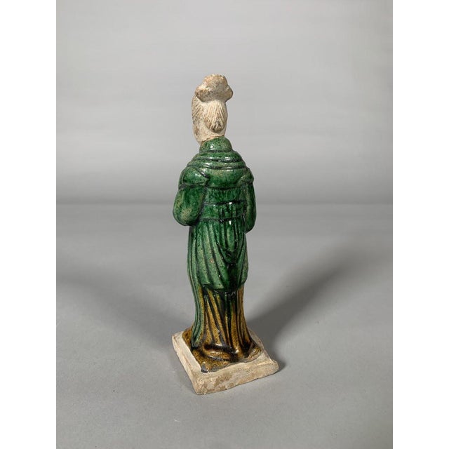 Sculpture of a court lady, China, Ming Dynasty (1368-1644), terracotta sculpture with green and brown glaze. Depicts a...