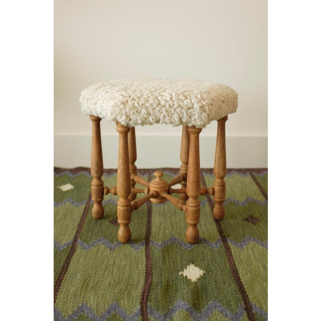 Decorative Scandinavian Modern Sheepskin stool. Hexagon shape covered in plush sheepskin and 6 oak wood carved legs that...