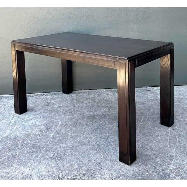 This striking Parsons-style desk is a masterclass in minimalist architectural design with a touch of Art Deco flair....