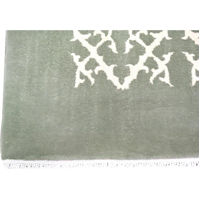 Hand-knotted with care using traditional rug-making techniques, this wool rug blends timeless craftsmanship with a modern...